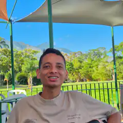 Man smiling under canopy with mountains