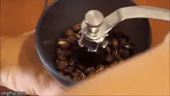 Hand crank coffee grinder in action