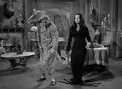 Fester and Morticia Addams dancing