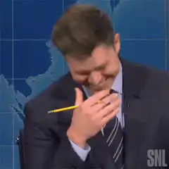 Colin Jost laughing with pencil