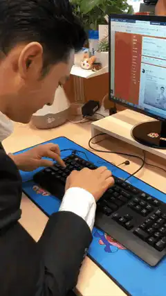 Man typing on keyboard with one finger