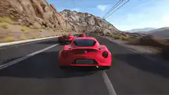 Red Alfa Romeo 4C racing on mountain road