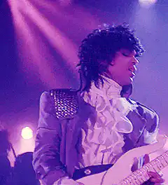 Prince playing guitar on stage