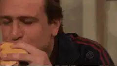 Joey Tribbiani eating a burger