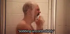 man sobbing uncontrollably in shower