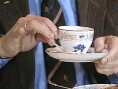 Man drinking tea with popping eyes