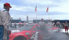 NASCAR driver celebrates on car roof
