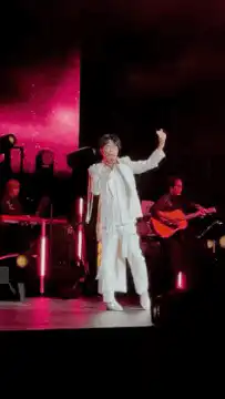 Harry Styles waving on stage