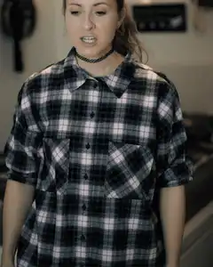 Woman in plaid shirt screaming and shaking hair
