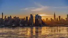Aerial view of Brooklyn Bridge and Manhattan skyline at sunset