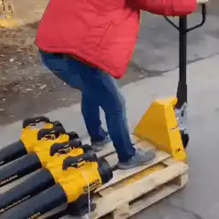Man rides pallet of leaf blowers