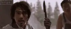 Stephen Chow holds knife then slumps