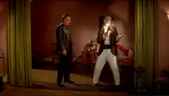Elvis impersonator singing on stage