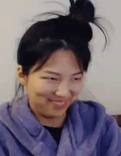 Woman in purple robe smiling
