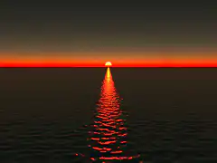 Sunset over ocean with red reflection