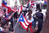 Woman in red pants dancing with Puerto Rican flag