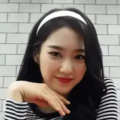 Woman in striped shirt flips hair and waves