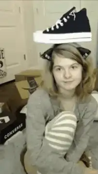 Girl balancing shoe on head