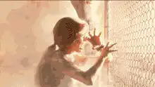 Person burning alive behind a fence