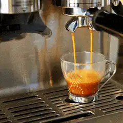 espresso pouring into glass cup