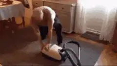 man struggling with vacuum cleaner