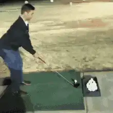 Man hits golf ball into camera