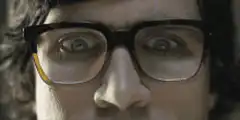 Man with glasses staring intensely