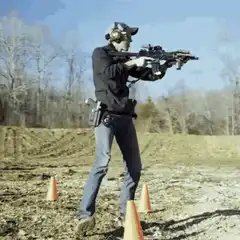 Man reloads rifle at outdoor range