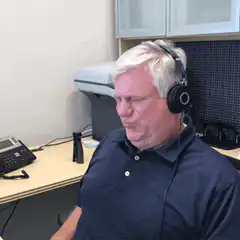 Man in headphones grimacing