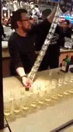 Bartender pours shot from giant bottle