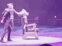 Magician reveals woman from chair
