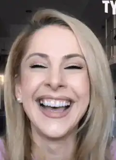 Woman laughing hysterically in kitchen
