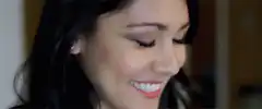woman laughing and covering face