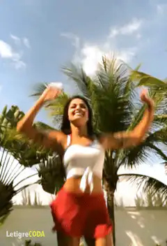 woman dancing outdoors with palm trees
