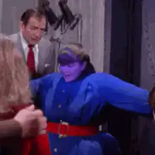 Purple woman in blue suit flexes muscles