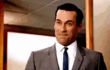 Don Draper smoking and smiling