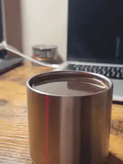 Coffee cup on desk with laptop