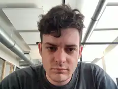 Man with messy hair looking down