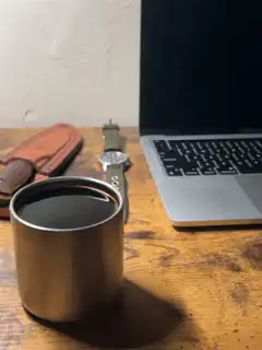 Coffee cup on desk with laptop