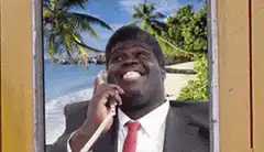 Man in suit on phone with beach background