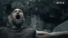Man screaming with arms outstretched