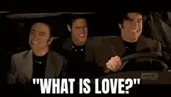 Three men laughing in car with 'WHAT IS LOVE?' text