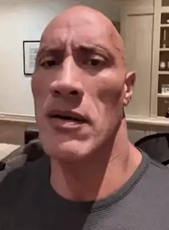 Dwayne Johnson pointing at his head