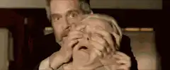 Man pulling woman's eyes open