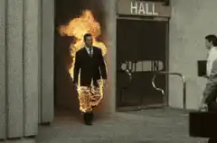 Man on fire walks through office