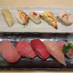 Two plates of assorted nigiri sushi