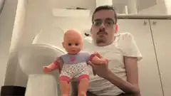 man throws baby doll into toilet