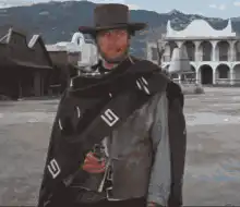 Man in poncho turns around