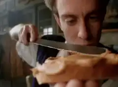 Man spreading peanut butter on toast