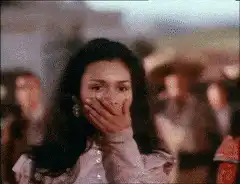 Woman covers mouth, man in sombrero yells